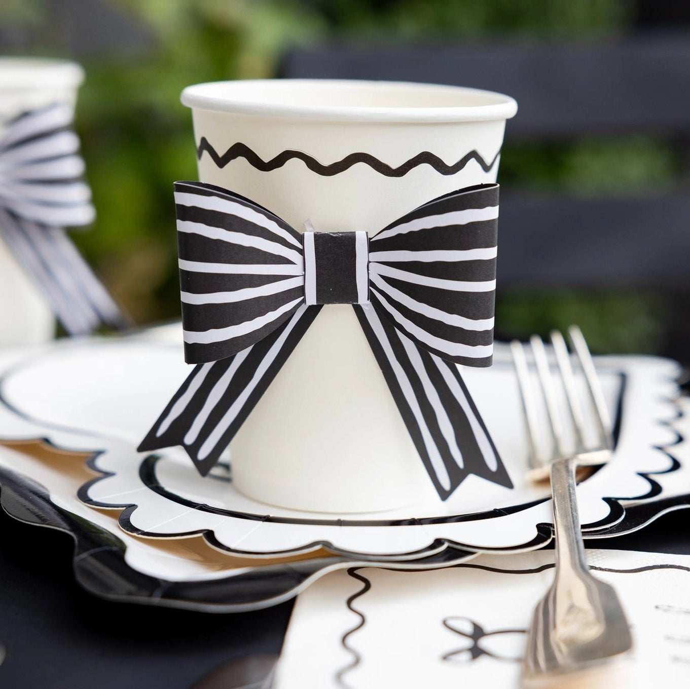 Cream party cup with black scalloped detail
