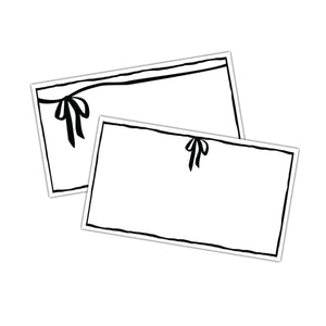 White place cards with black bow designs