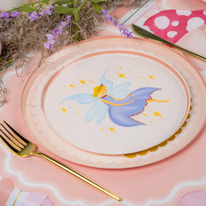 Decorative plate with fairy design on a pink table setting