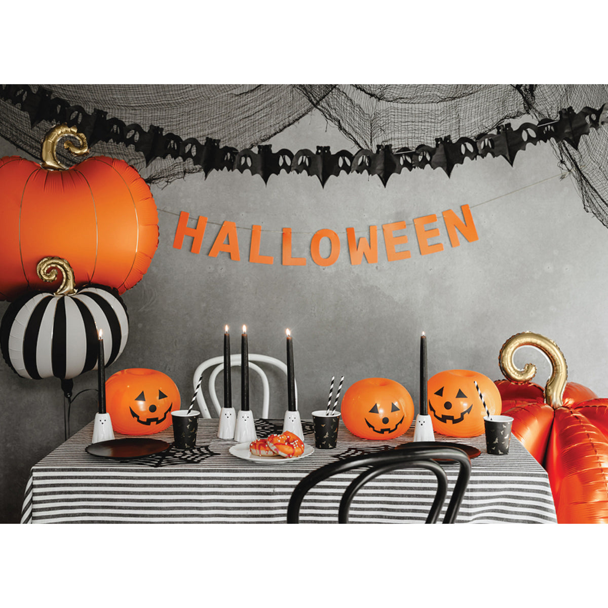 Pumpkin-shaped balloon with black, white, and gold details