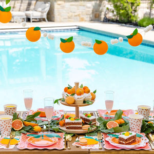 Citrus orange felt garland styled on outdoor party table