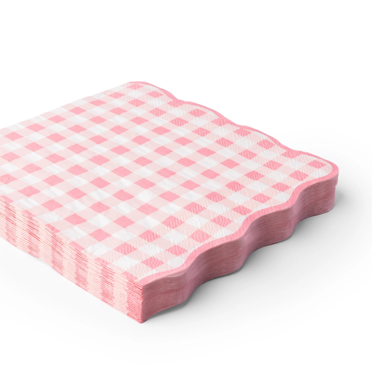 Pink gingham scalloped lunch napkins stacked on a white background