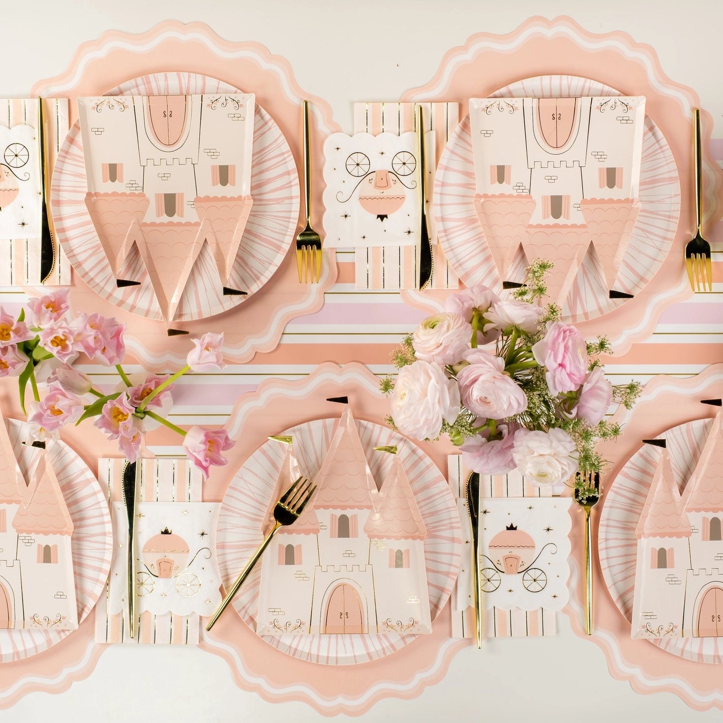 Pink castle paper dessert plates styled on a princess-themed table