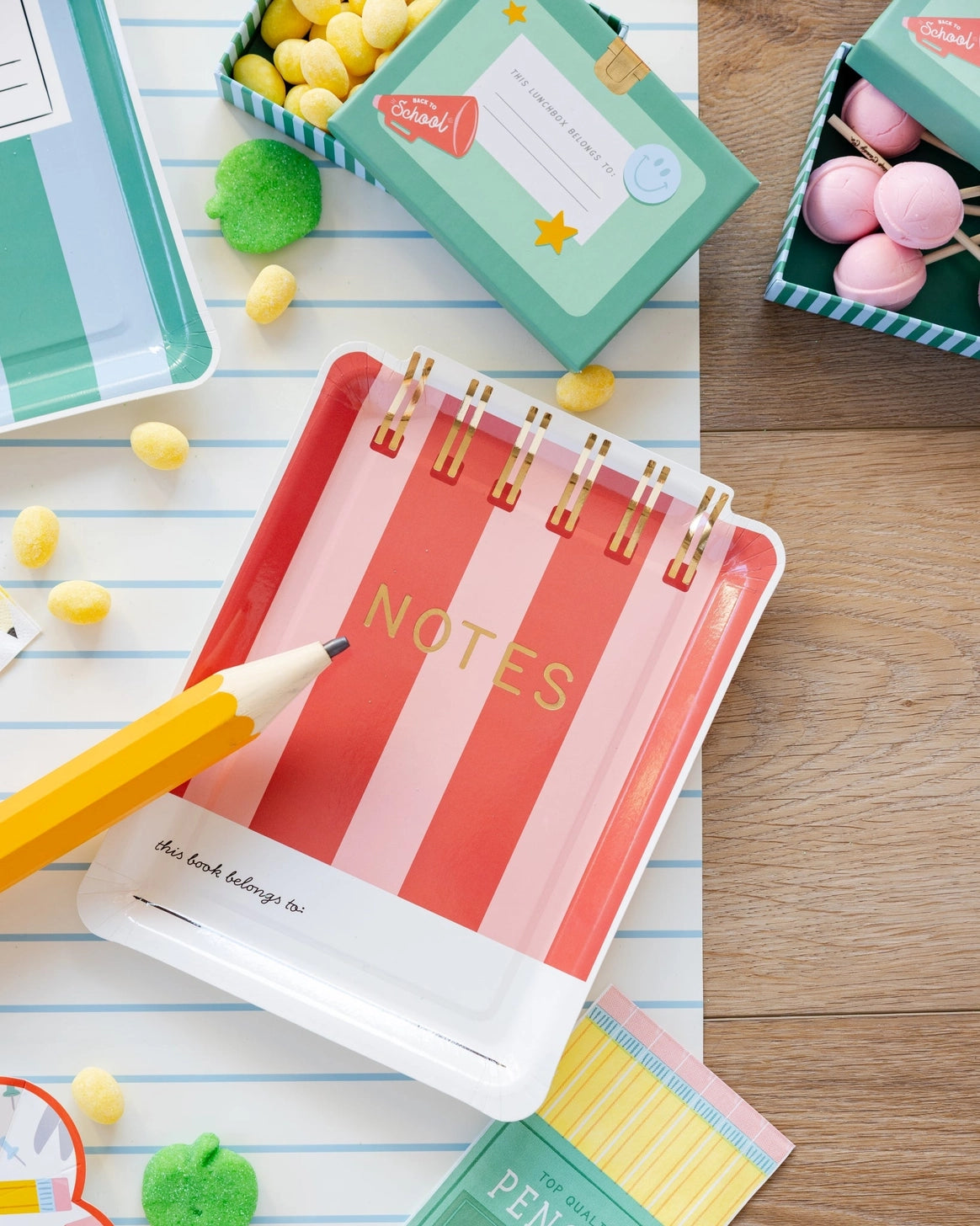Paper plates shaped like sprial notebooks in red and pink stripes