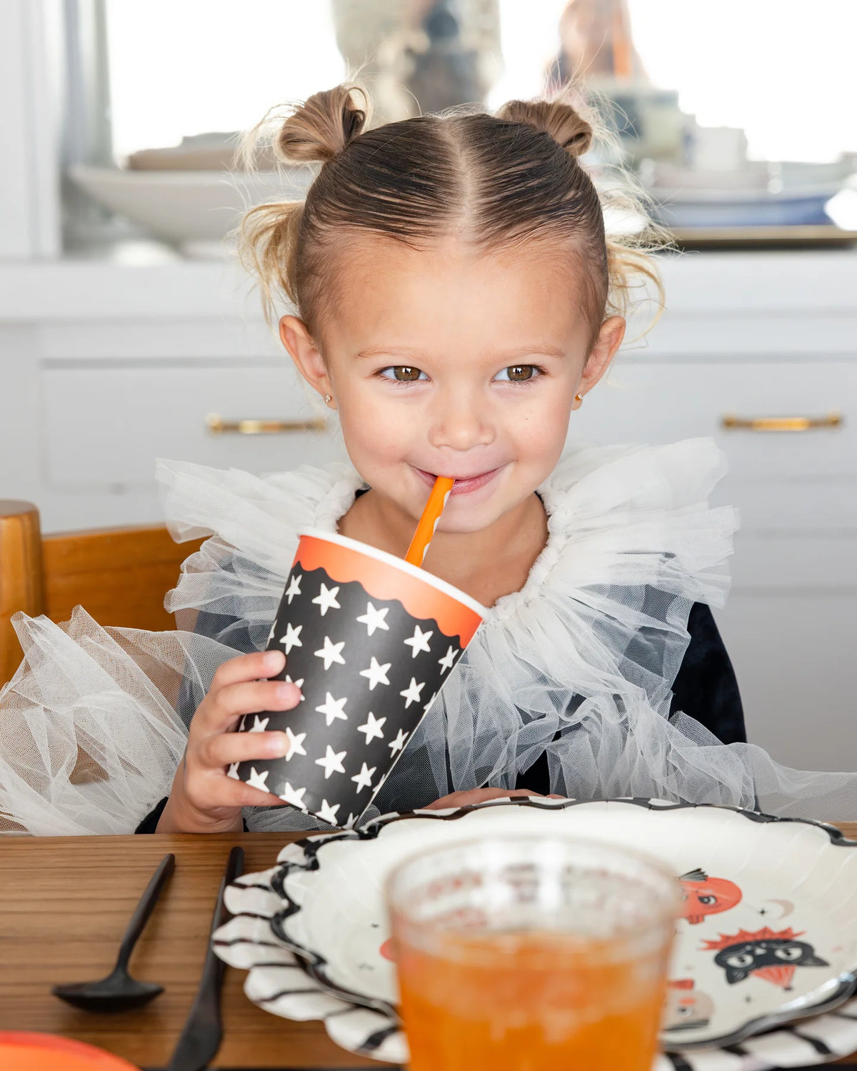 Cream plastic Halloween straws with orange and black details