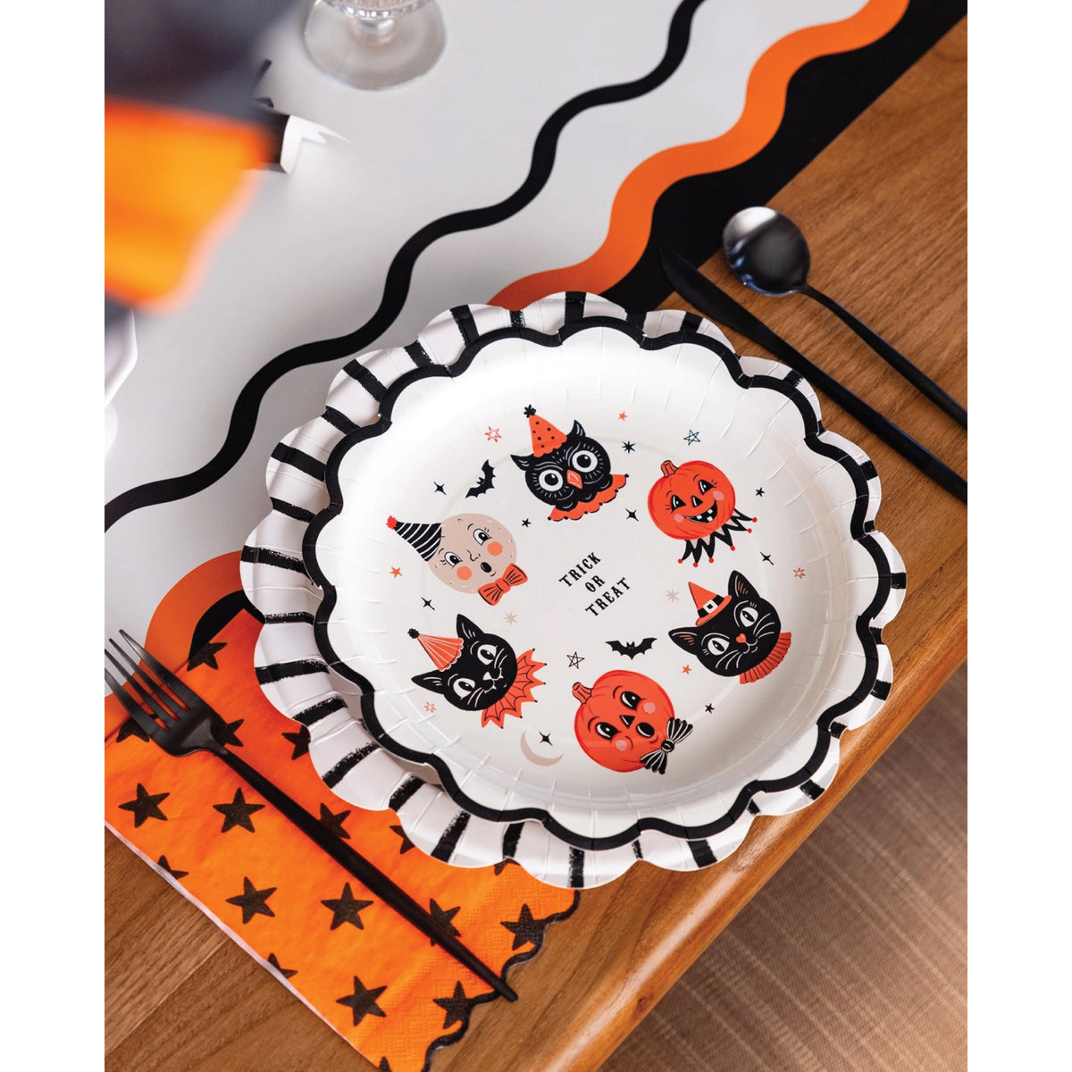 Cream paper dinner plate with pumpkins, black cats, owl, and bats