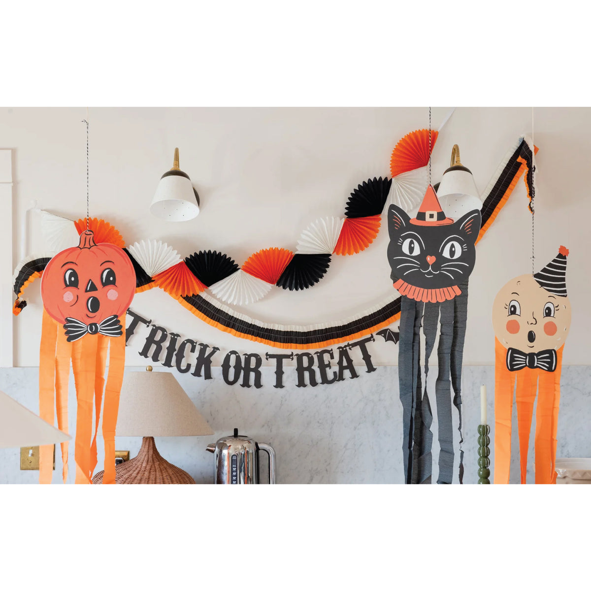 Double-sided pumpkin, black cat, and costumed Halloween decorations