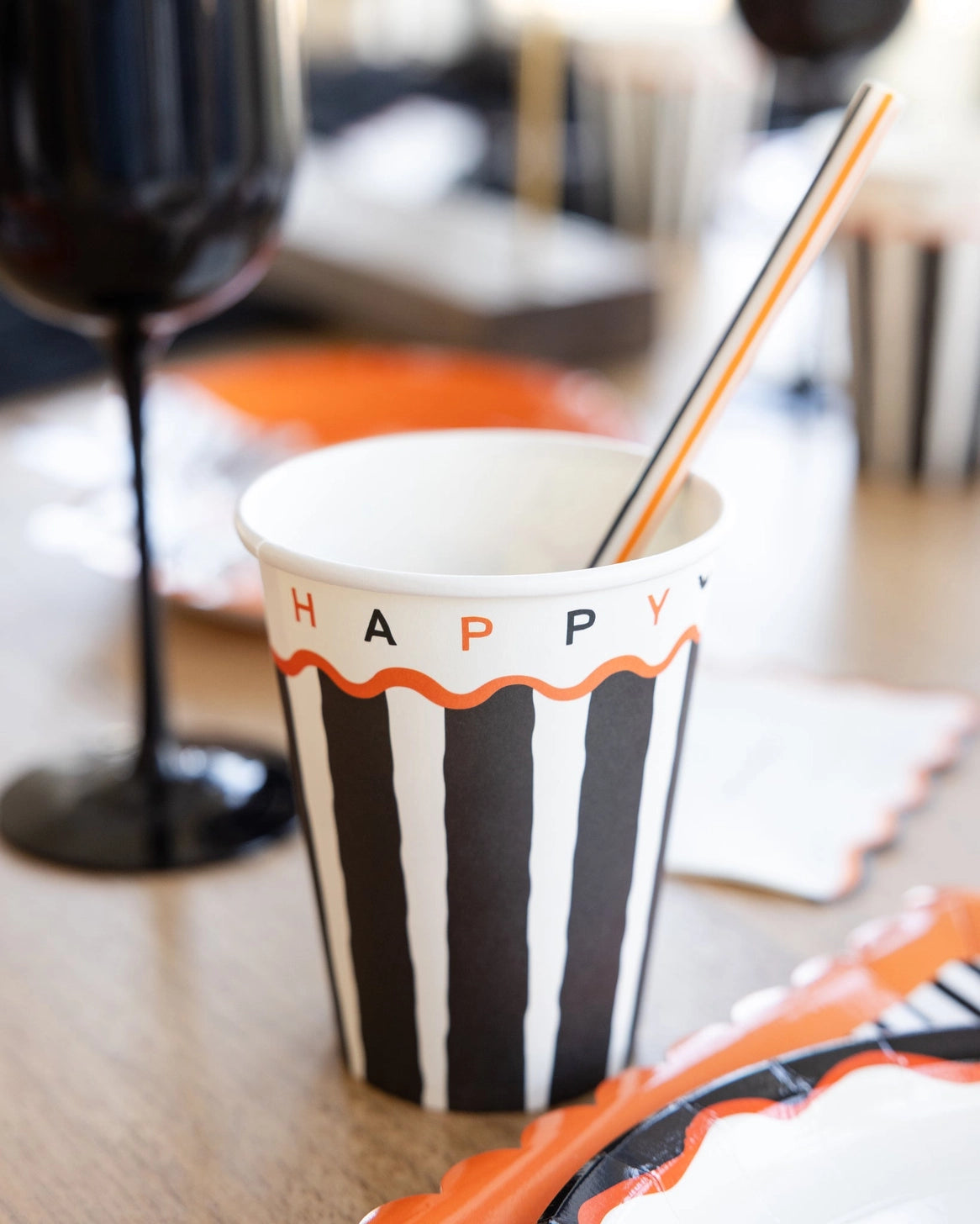 Halloween paper cup with black stripes and Happy Halloween lettering