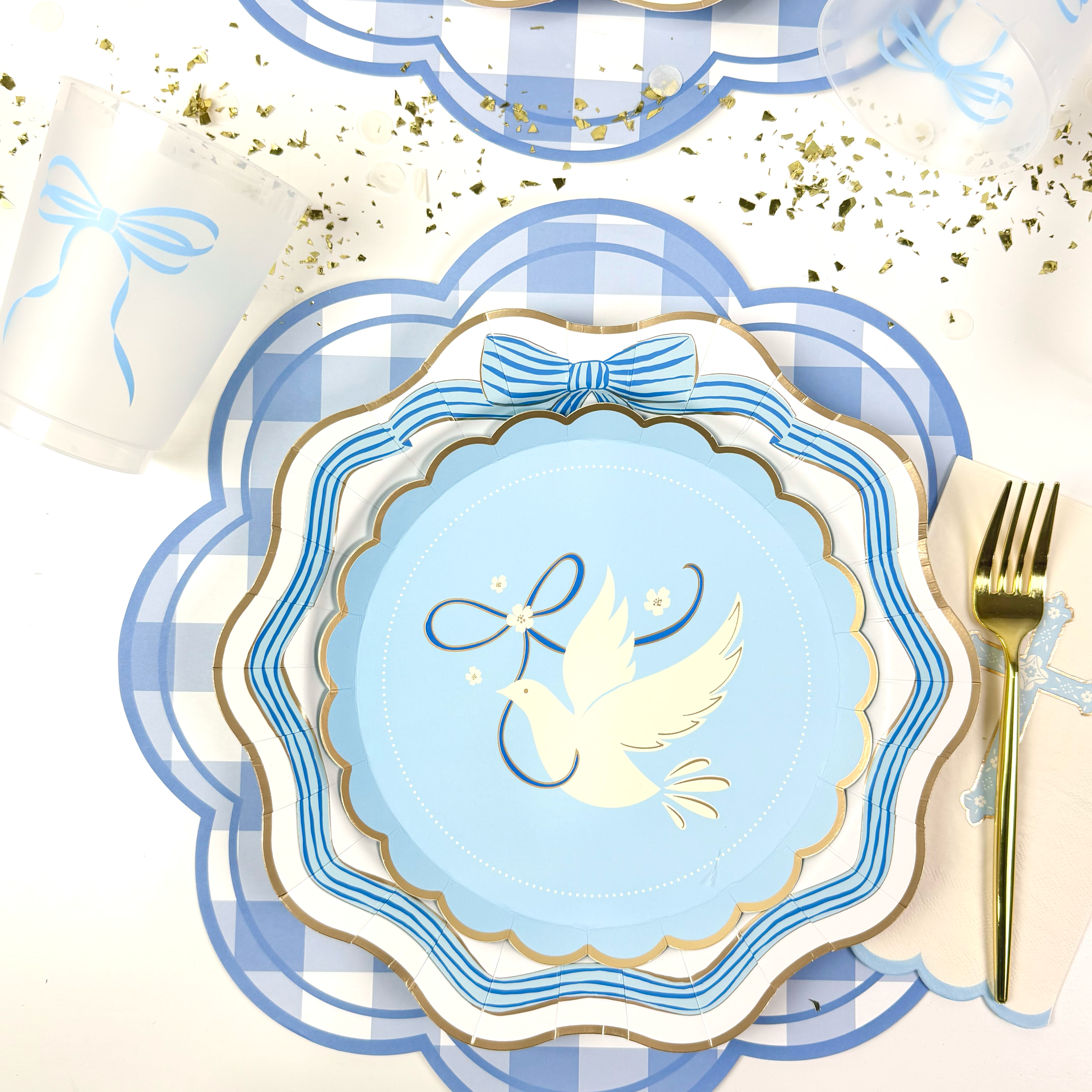 Blue dove baptism plates on a blue gingham placemat.