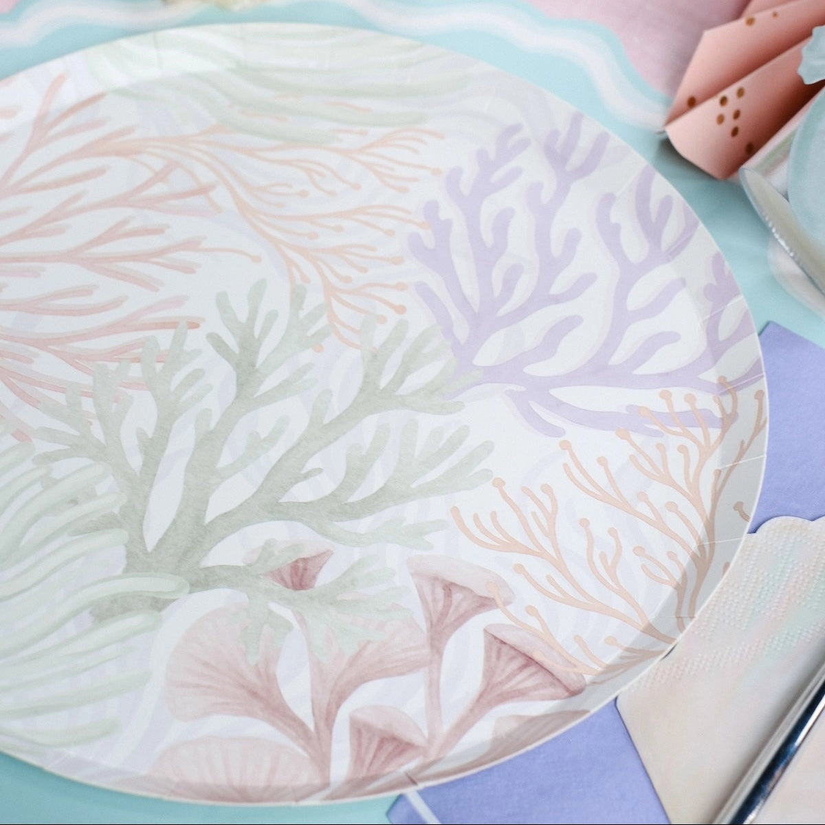 Coral-themed dinner plate in soft pink, mint, and lavender tones