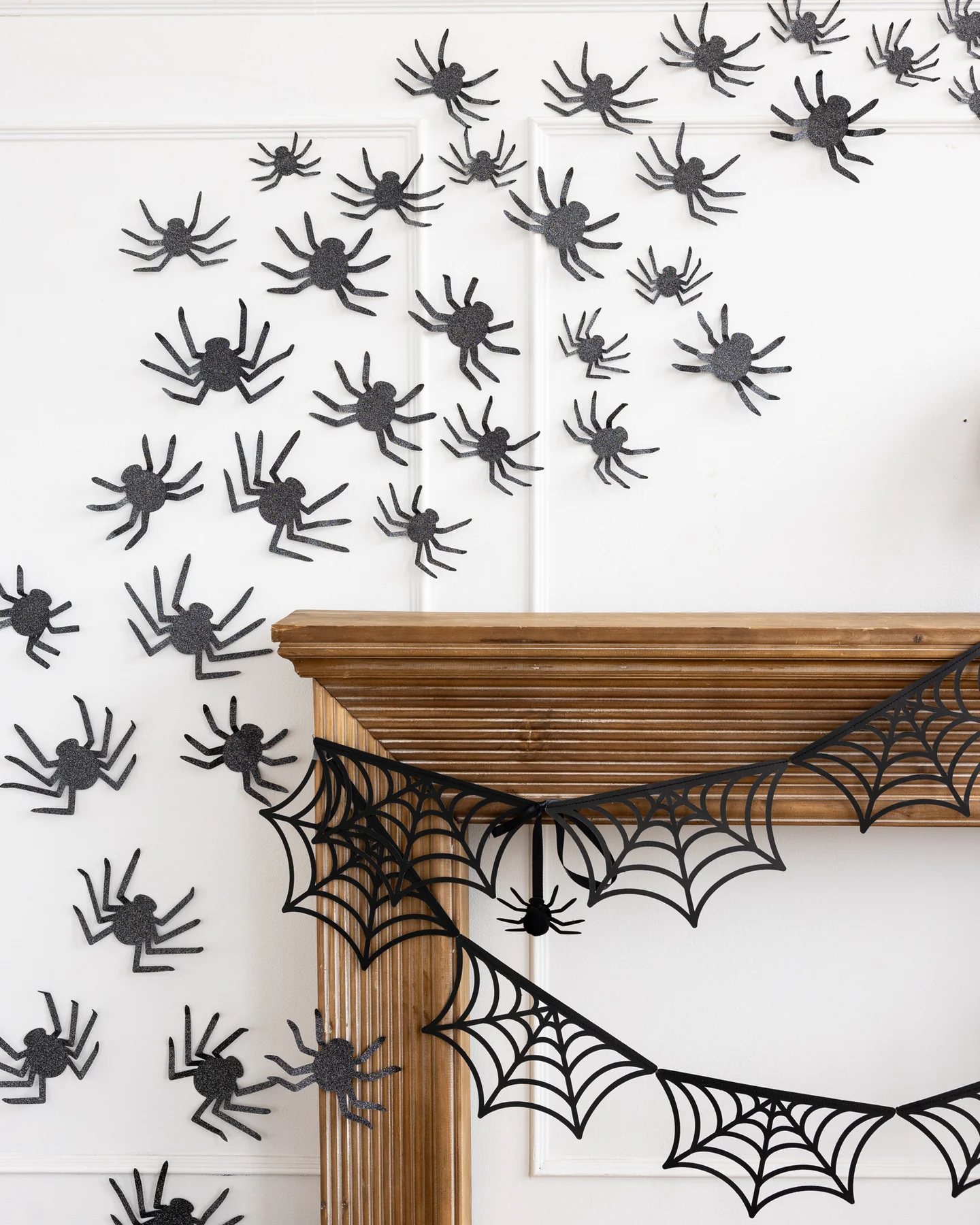Black Glitter Spiders Halloween Wall Decorations over a mantle