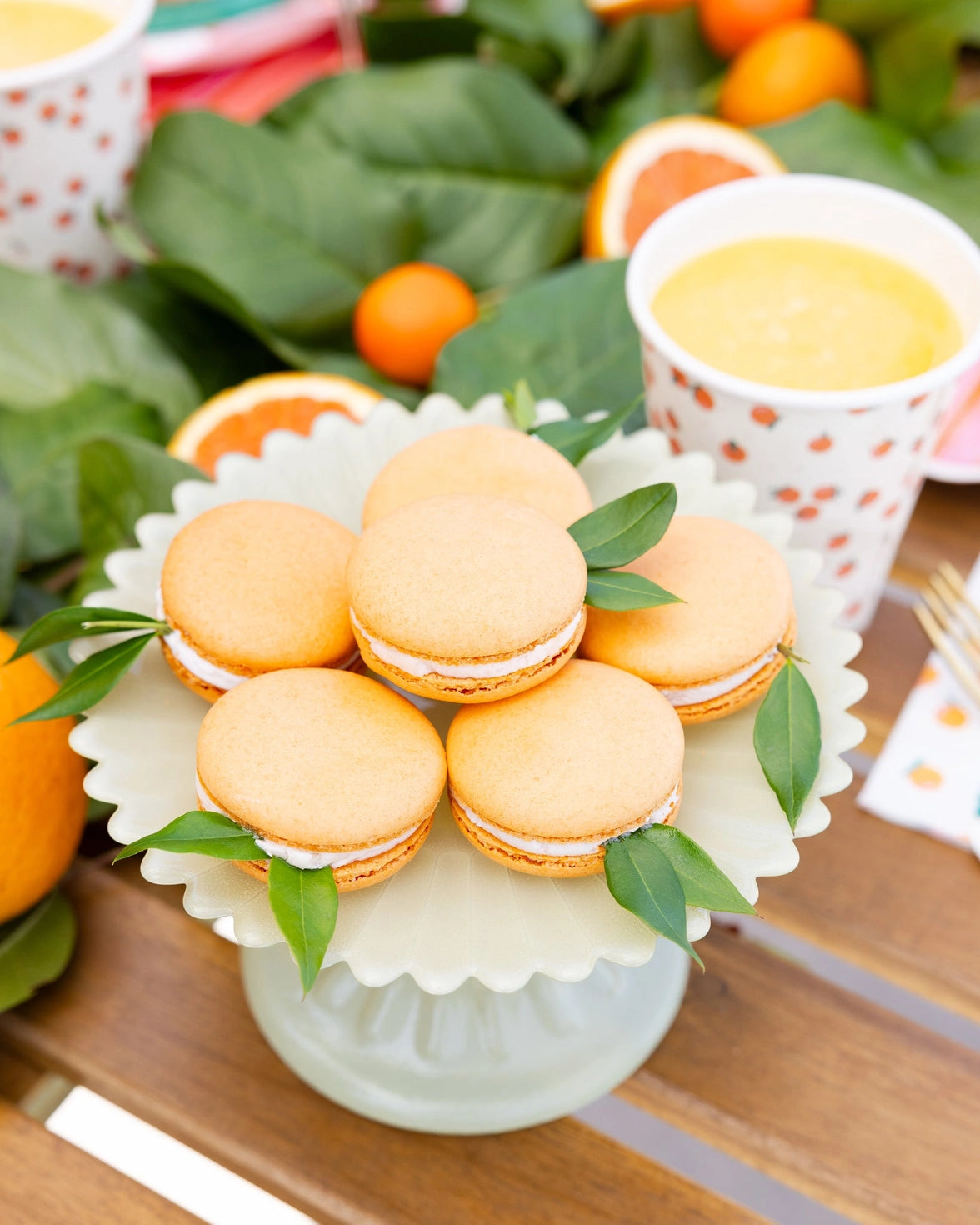 Orange themed party cups with green leaf details