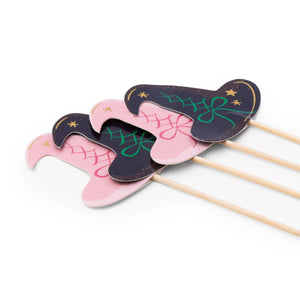 Halloween cupcake toppers shaped like witch hats on wooden picks