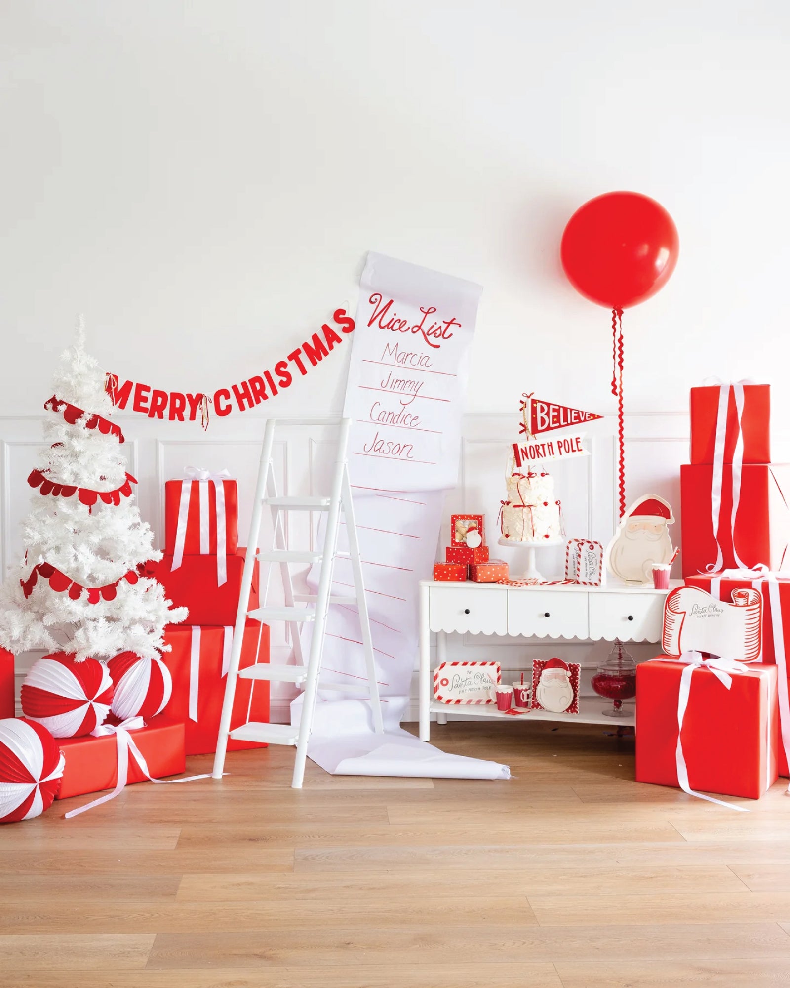 Red and white Christmas party display with Santa Claus party supplies