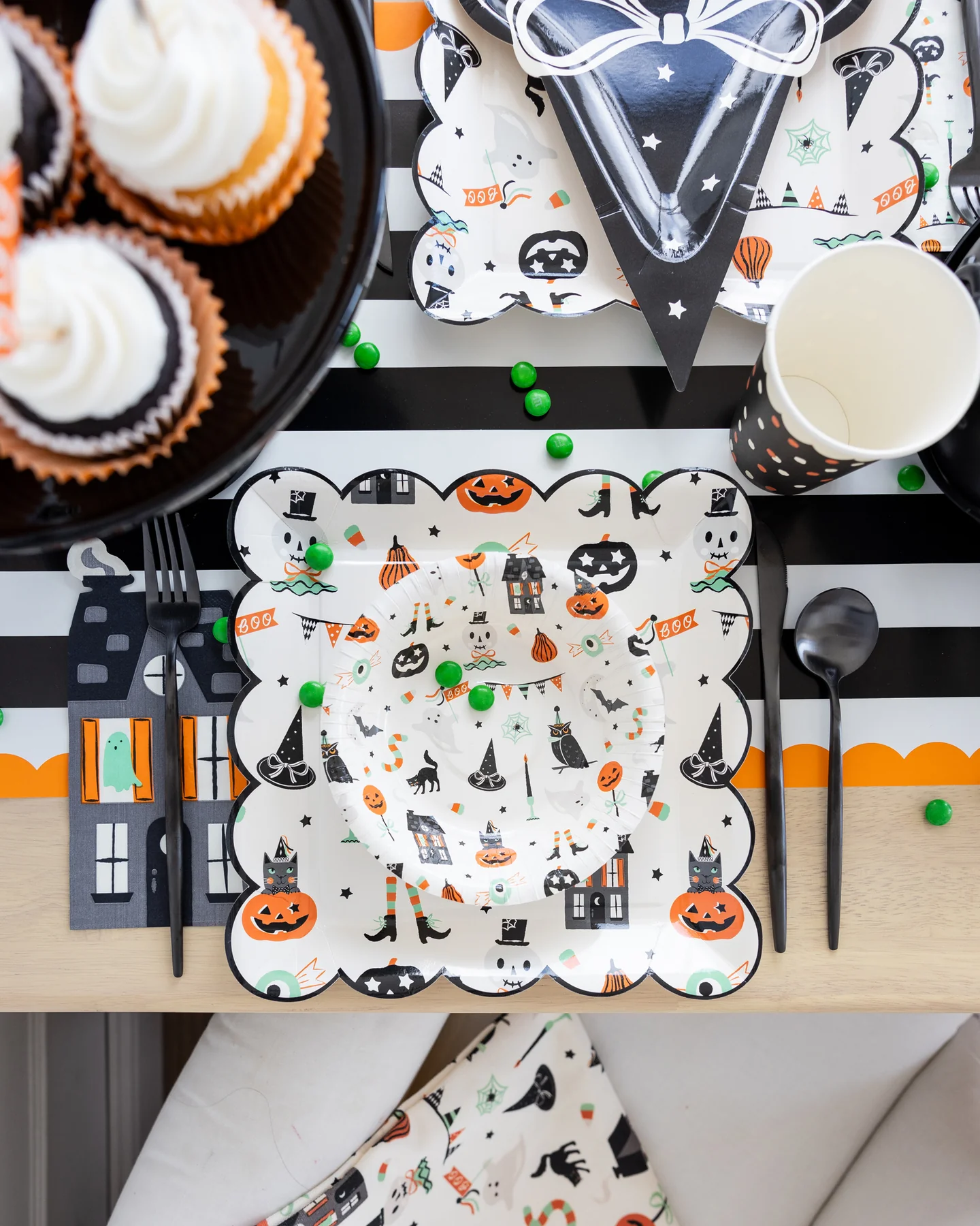 Halloween-themed table setting with Halloween plates and a haunted house napkin