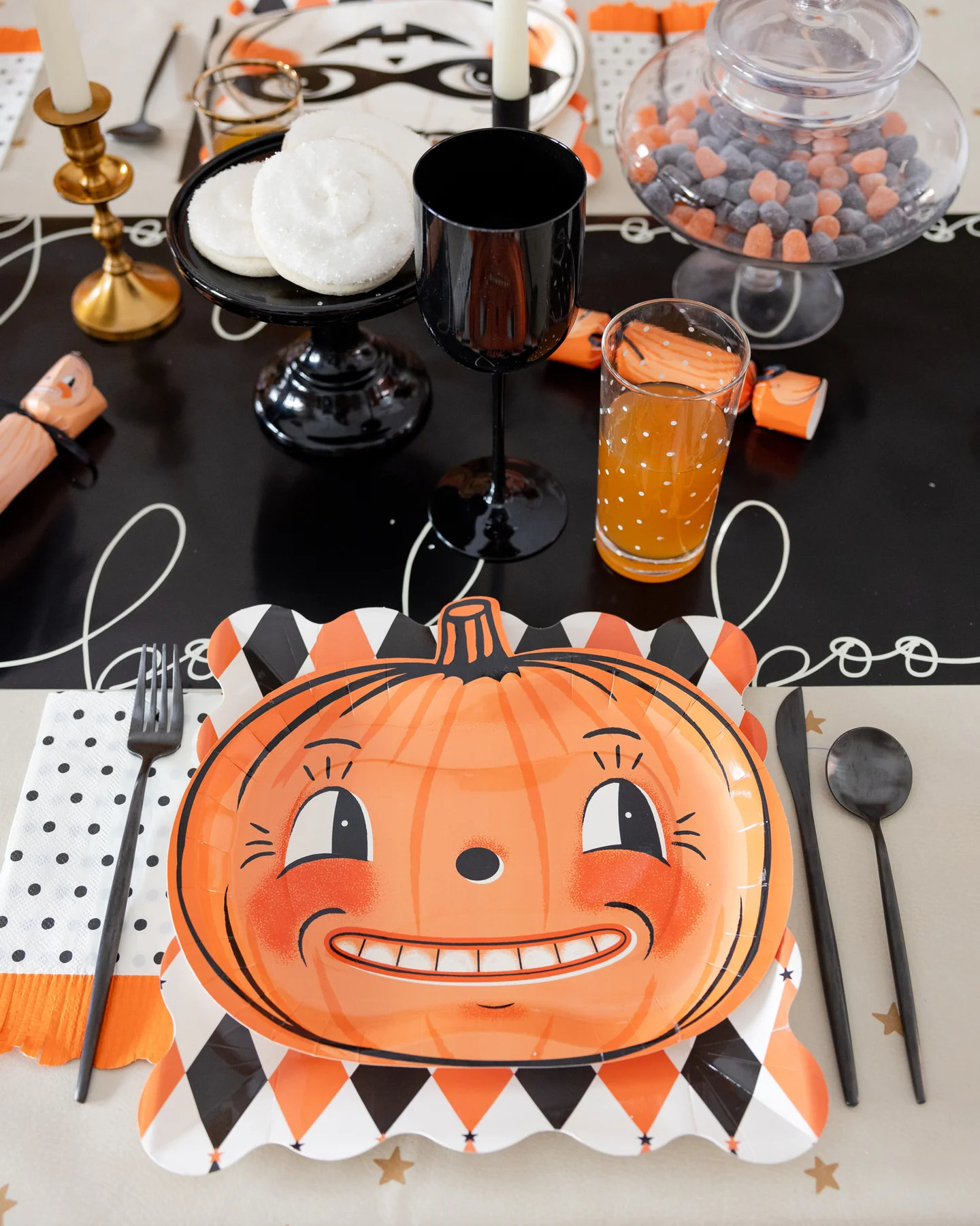 Halloween party table setting with a vintage pumpkin plate and decorative elements.