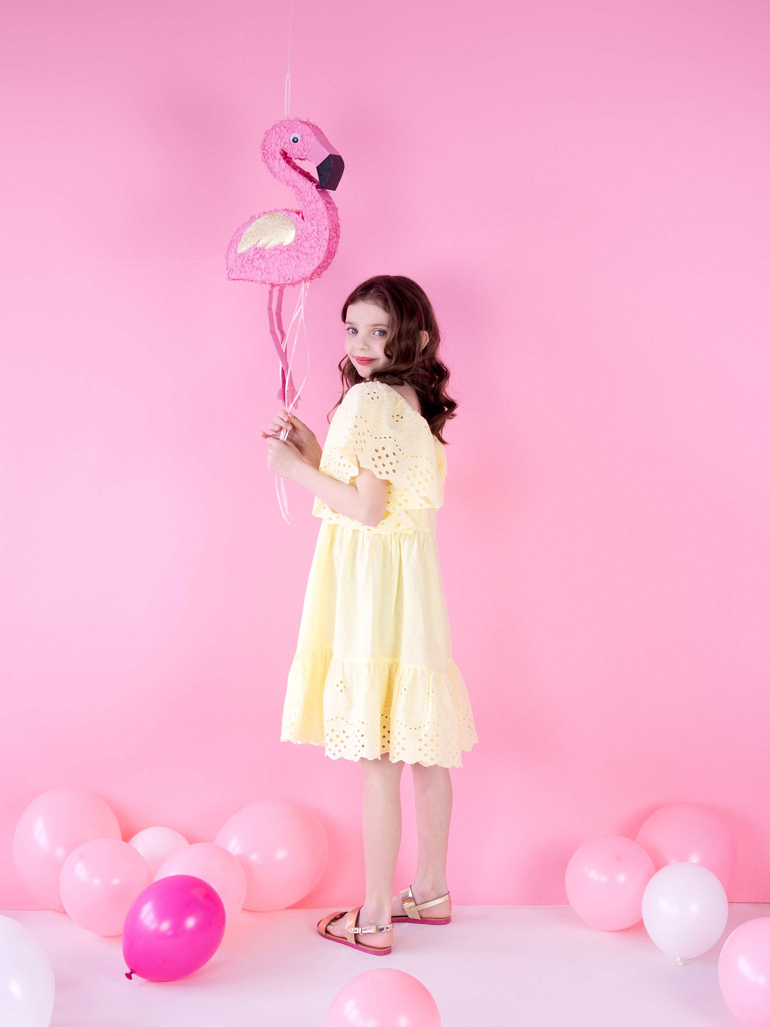 girl with flamingo piñata