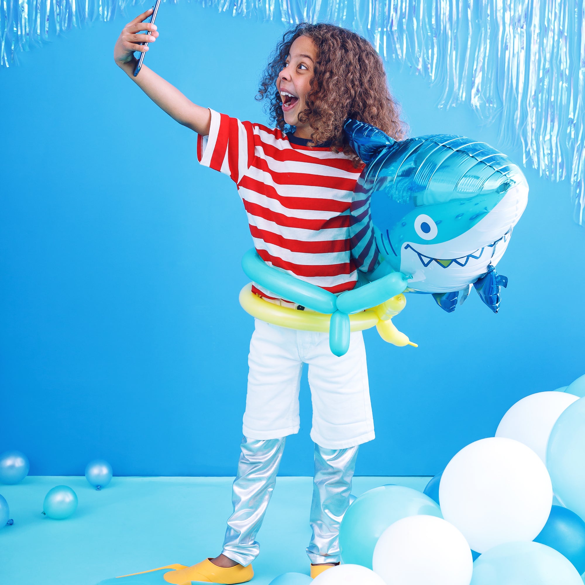 Girl with shark balloon