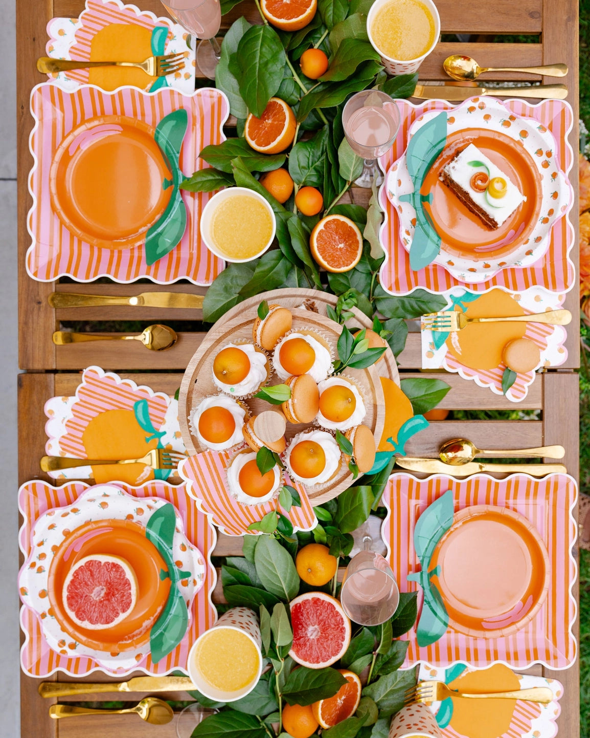 Orange fruit party plates styled on a table