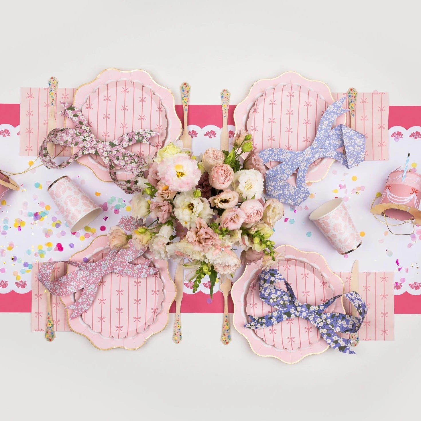 Pink bow themed party plates styled on table