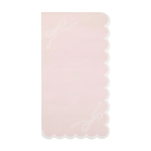 Pink guest towel with white bow accents