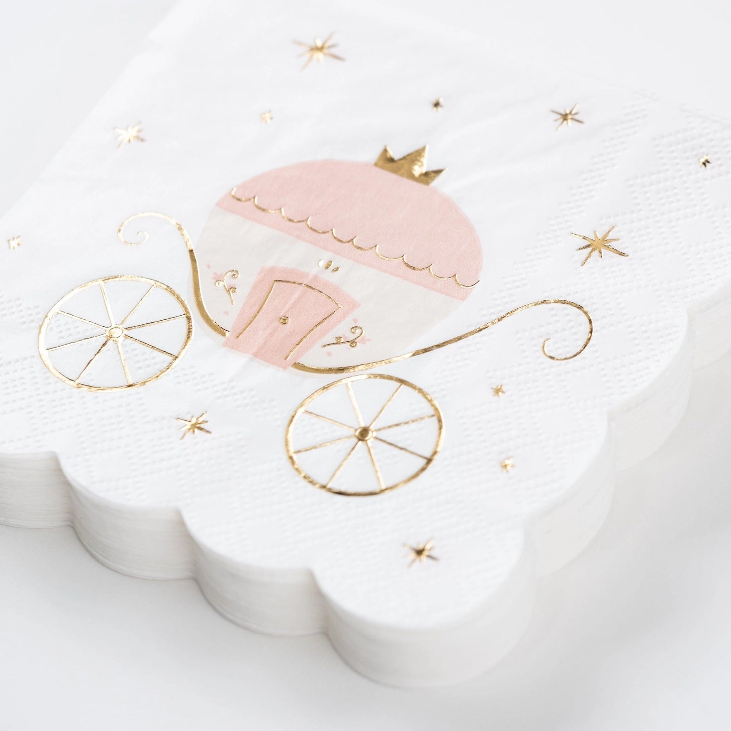 Stack of princess party dessert napkins with gold foil accents