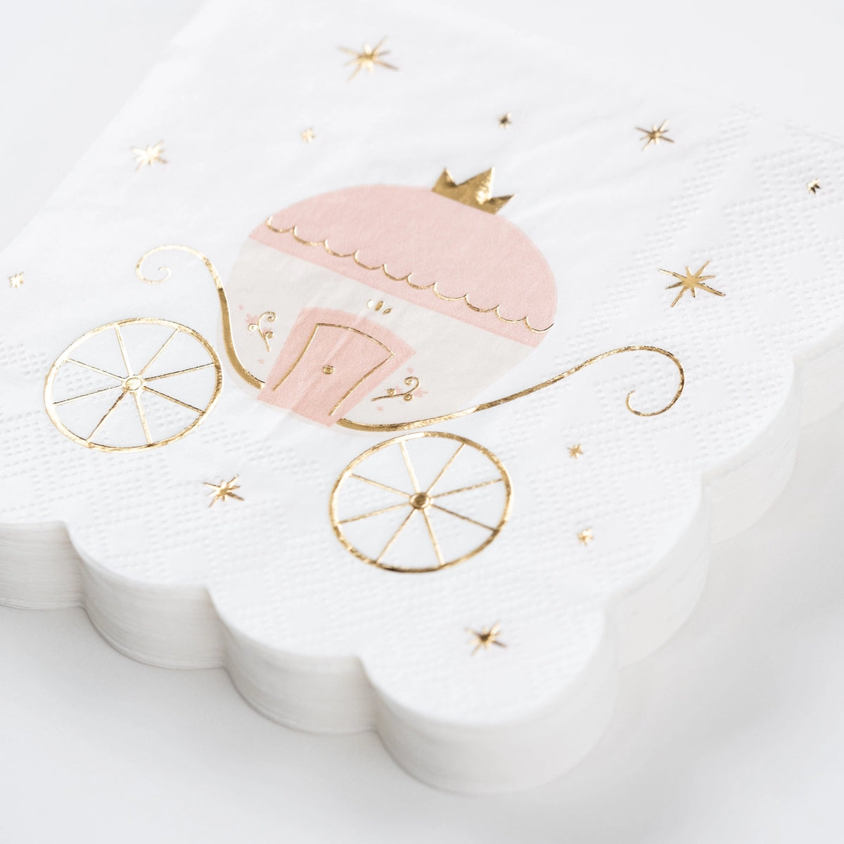 Stack of princess party dessert napkins with gold foil accents