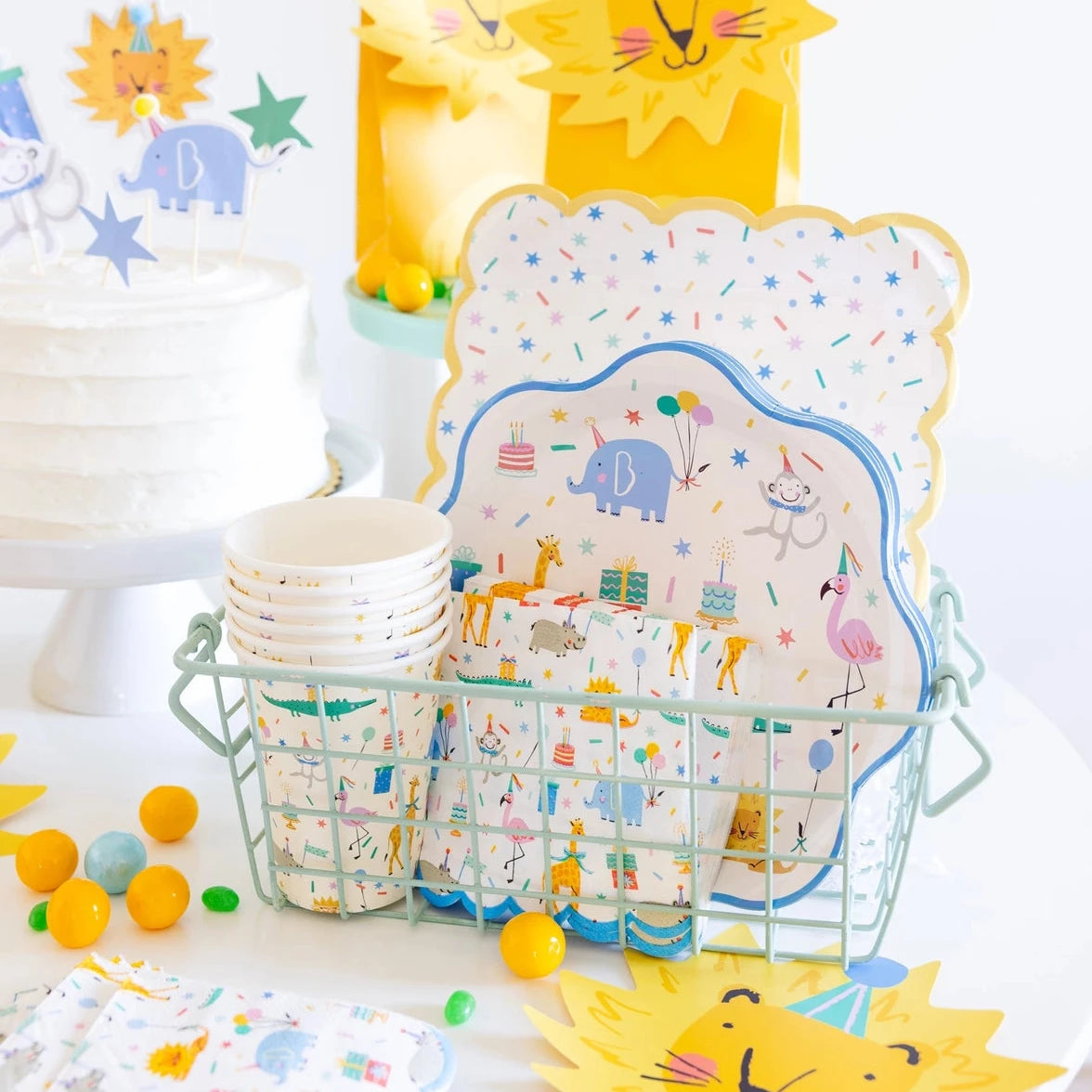 Animal party cups displayed on a decorated dessert table