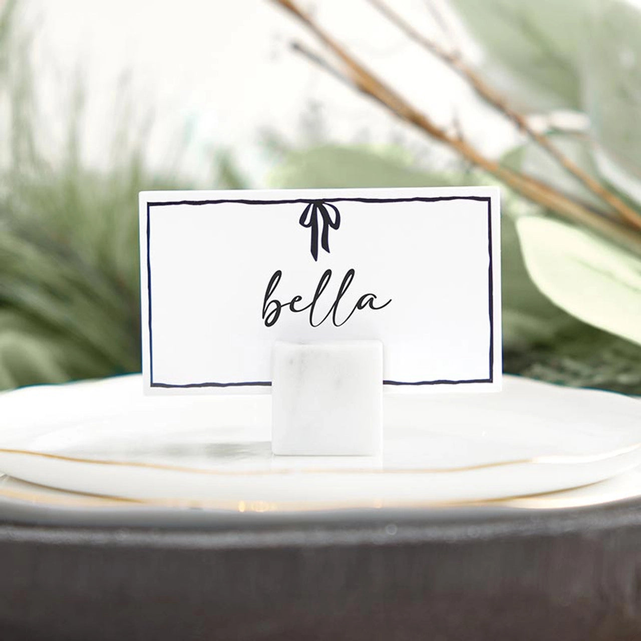 White place cards with black bow designs