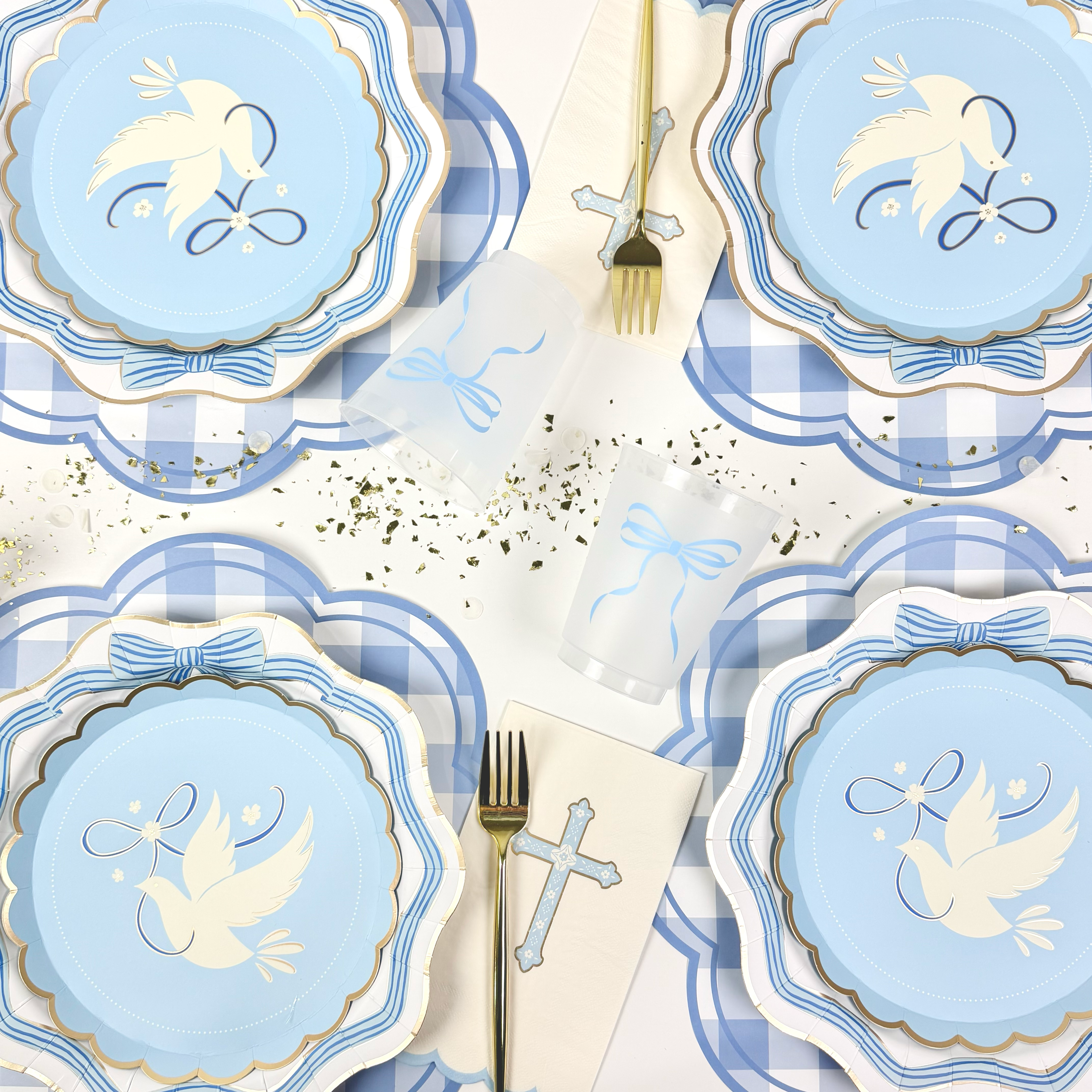 Blue baptism table setup with bow plates, bow cups and cross napkins.