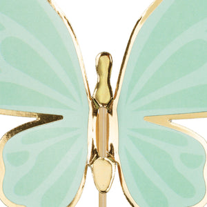 Close up of mint green butterfly on a wooden pick