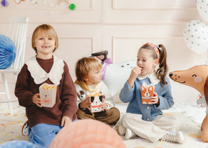 Children eating out of dog popcorn boxes