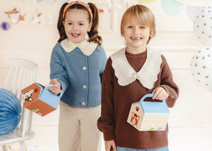 Children holding doghouse favor boxes