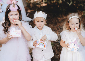 Children with rainbow, castles and unicorn treat boxes