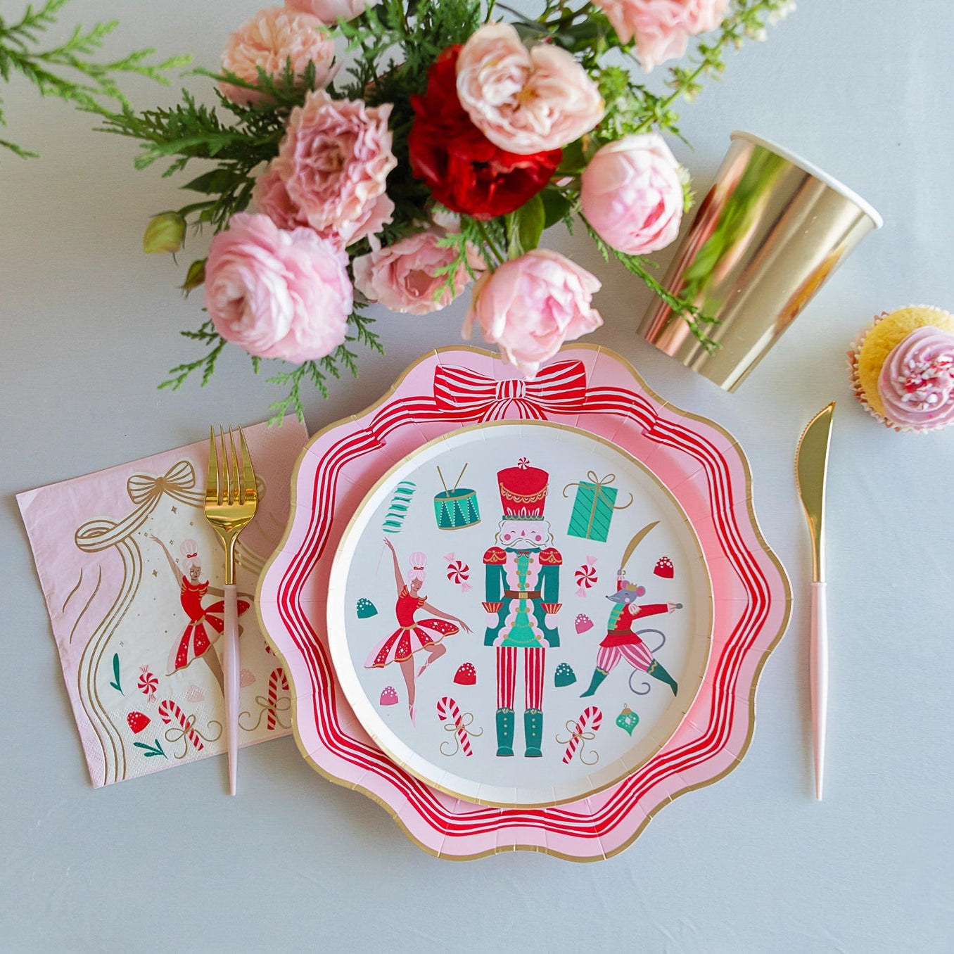 Pink Christmas dinner plate with red and white striped bow