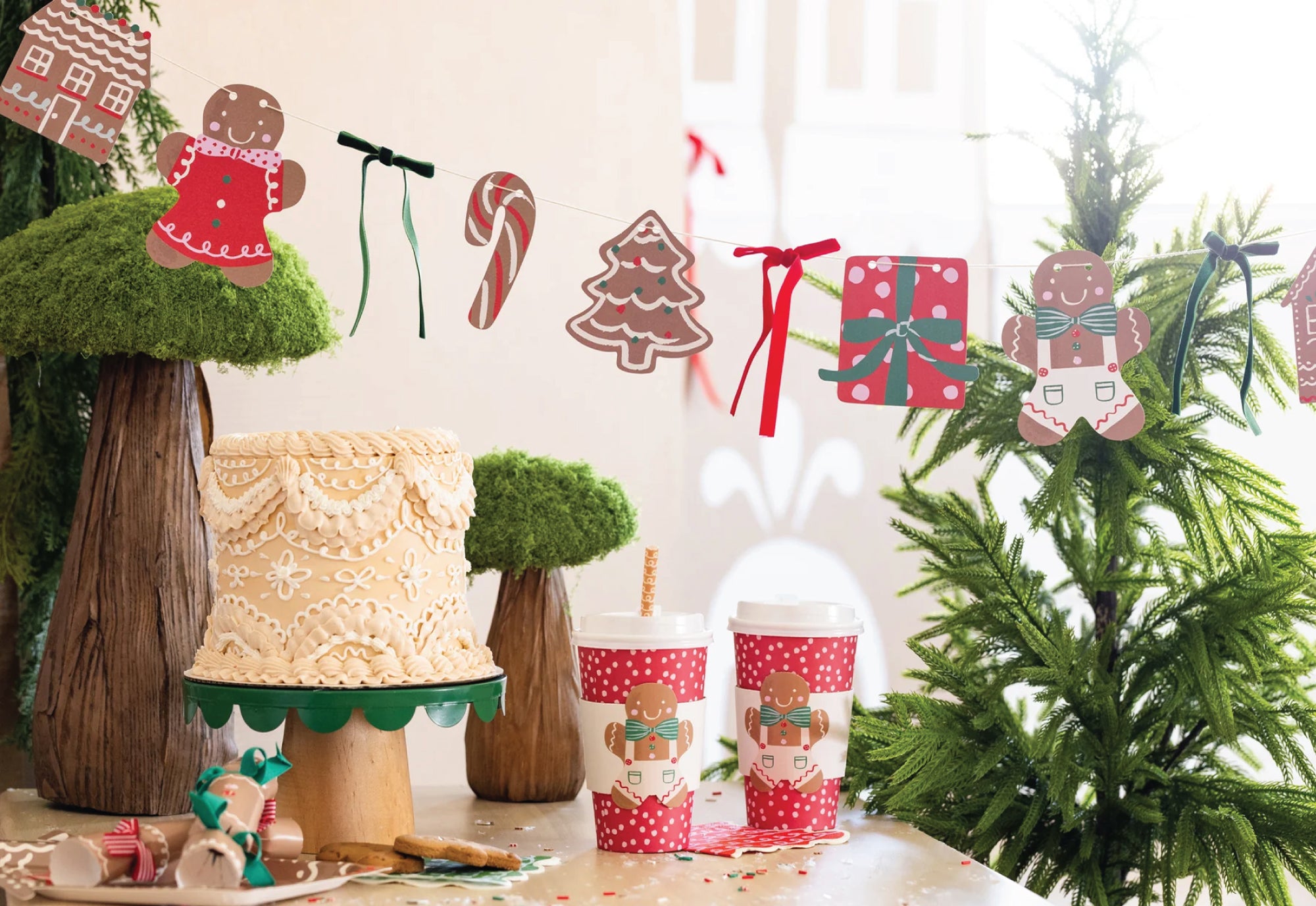 Decorative Christmas treat table with a gingerbread christmas garland and gingerbread cups on the table