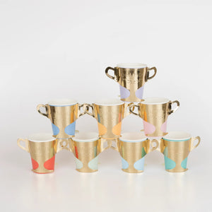 Assorted colors of paper cups with gold foil sleeves shaped like trophies