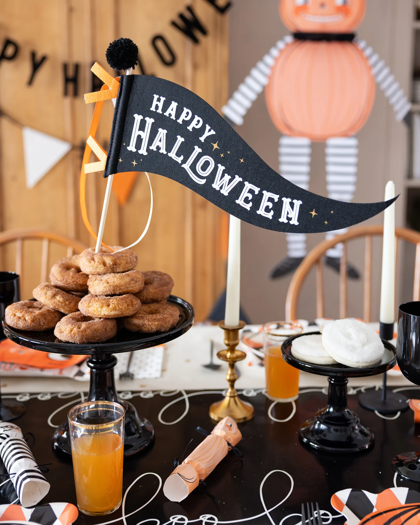 Halloween table setting with Happy Halloween Felt Pennant Flag on a donut tower