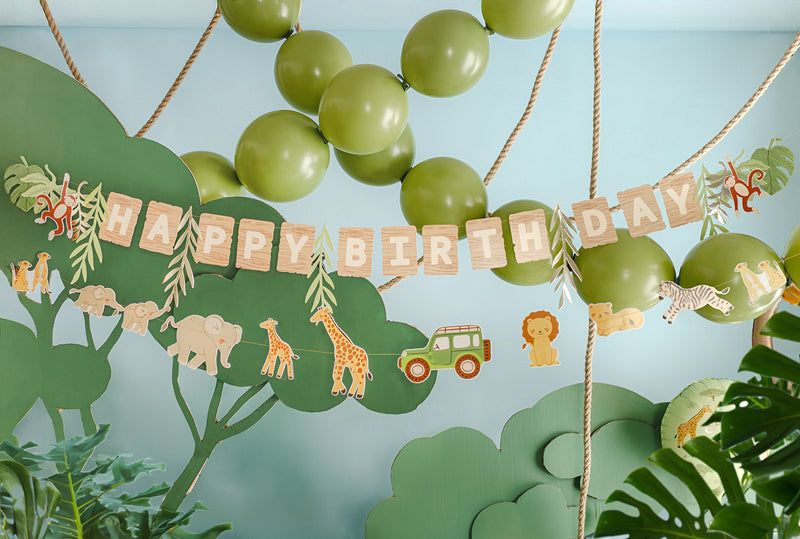 Jungle themed birthday banner with tropical leaves