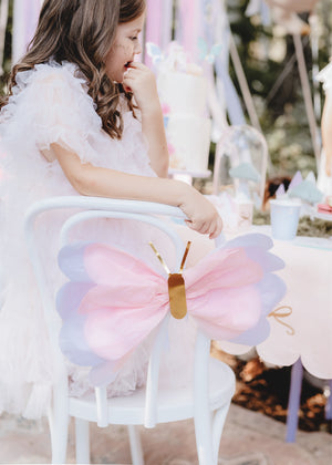 Pink Tissue Paper Butterfly Decoration hanging on  white chair