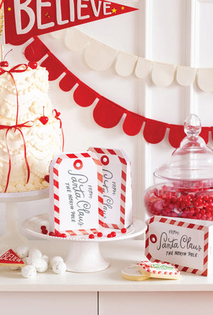 Decorative setup with candy jars and Gift from Santa Claus Treat Bags 