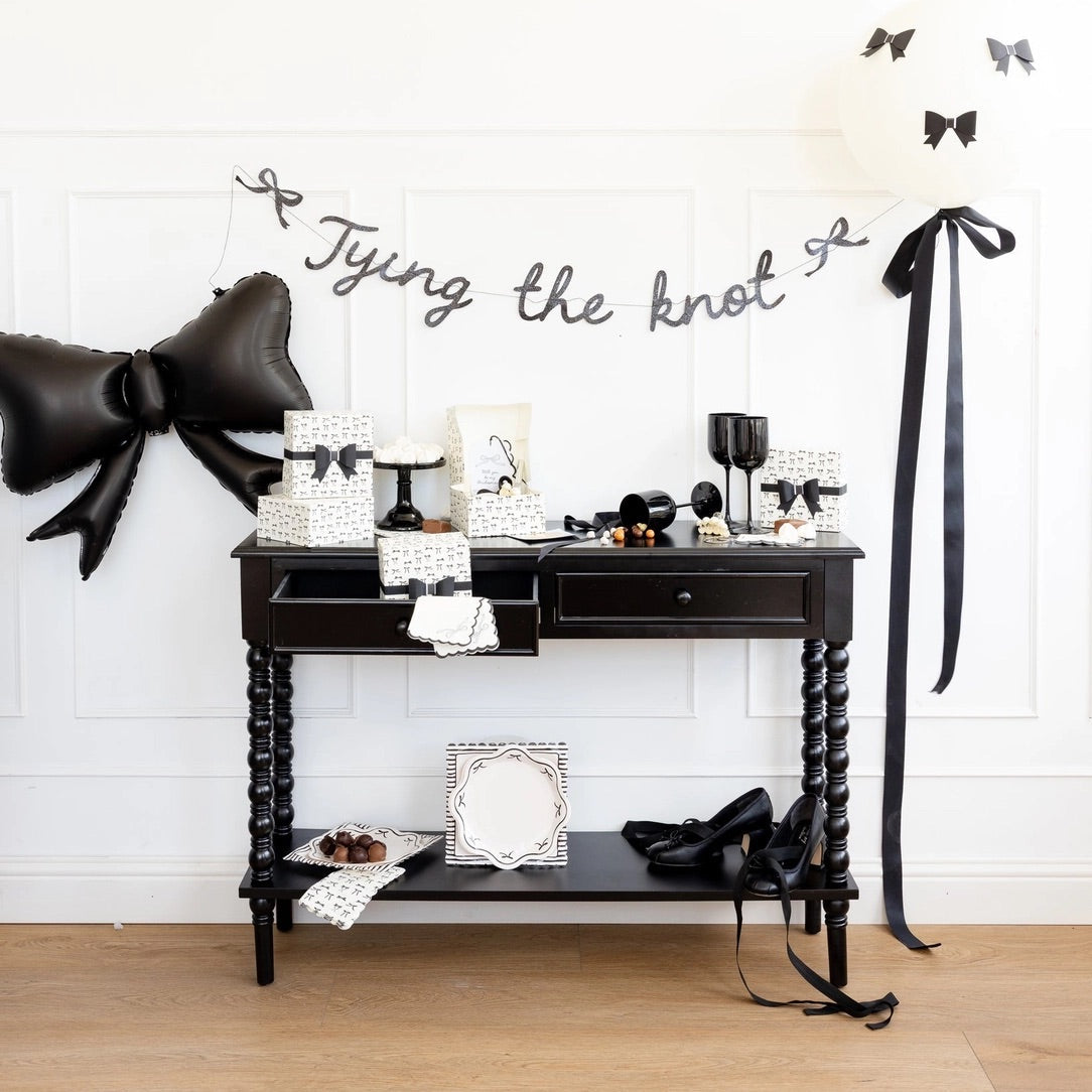 Black glitter “Tying the knot” banner with bows