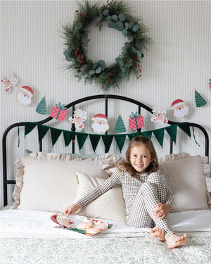 Child sitting on bed with Whimsical Christmas Party Decorations