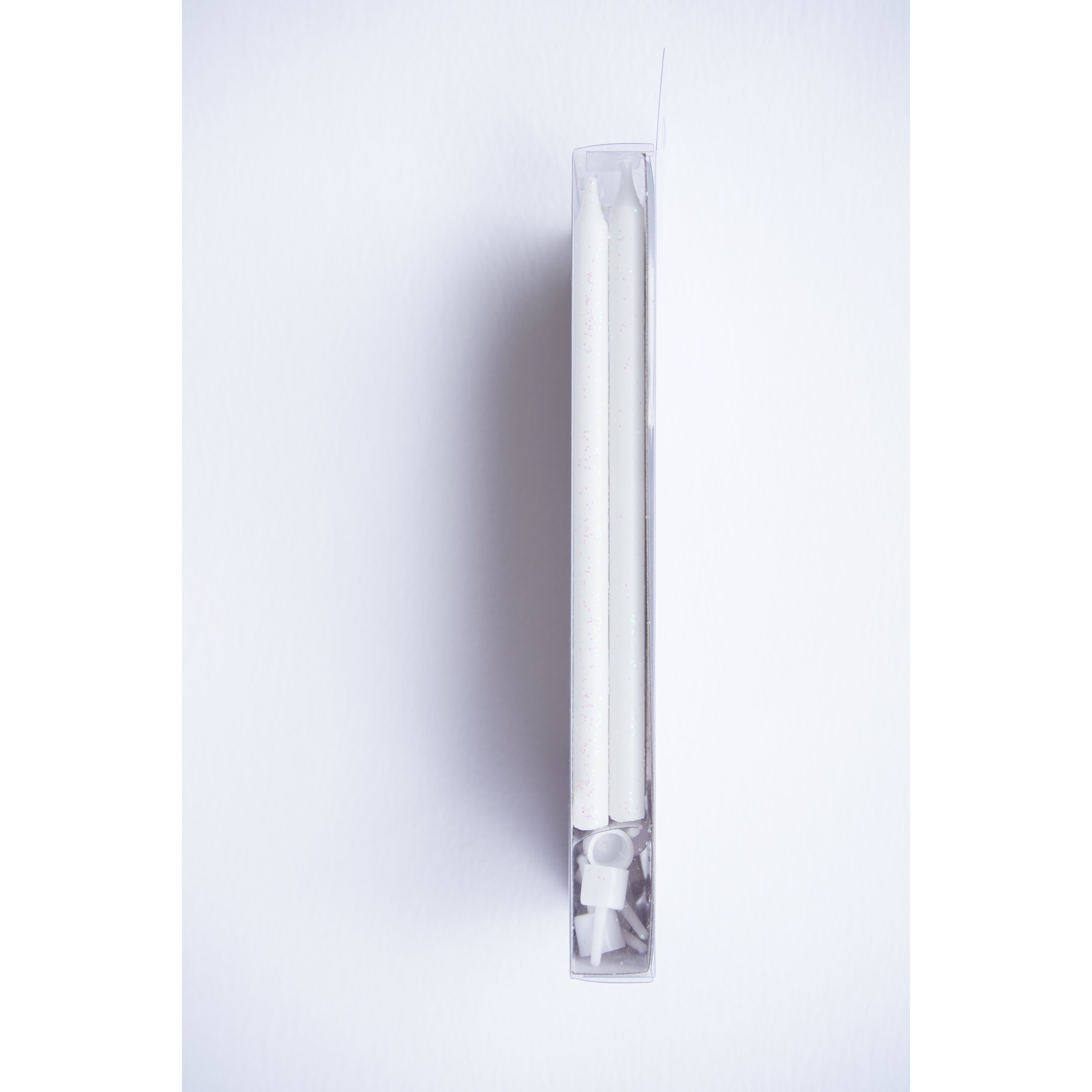 side view of Tall White Glitter Candle Set 16ct.