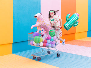 girl with shopping cart full of balloons