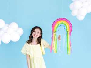 Girl with rainbow piñata