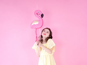 girl and flamingo piñata
