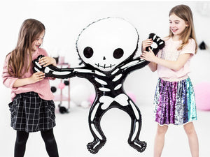 kids holding giant skeleton balloon